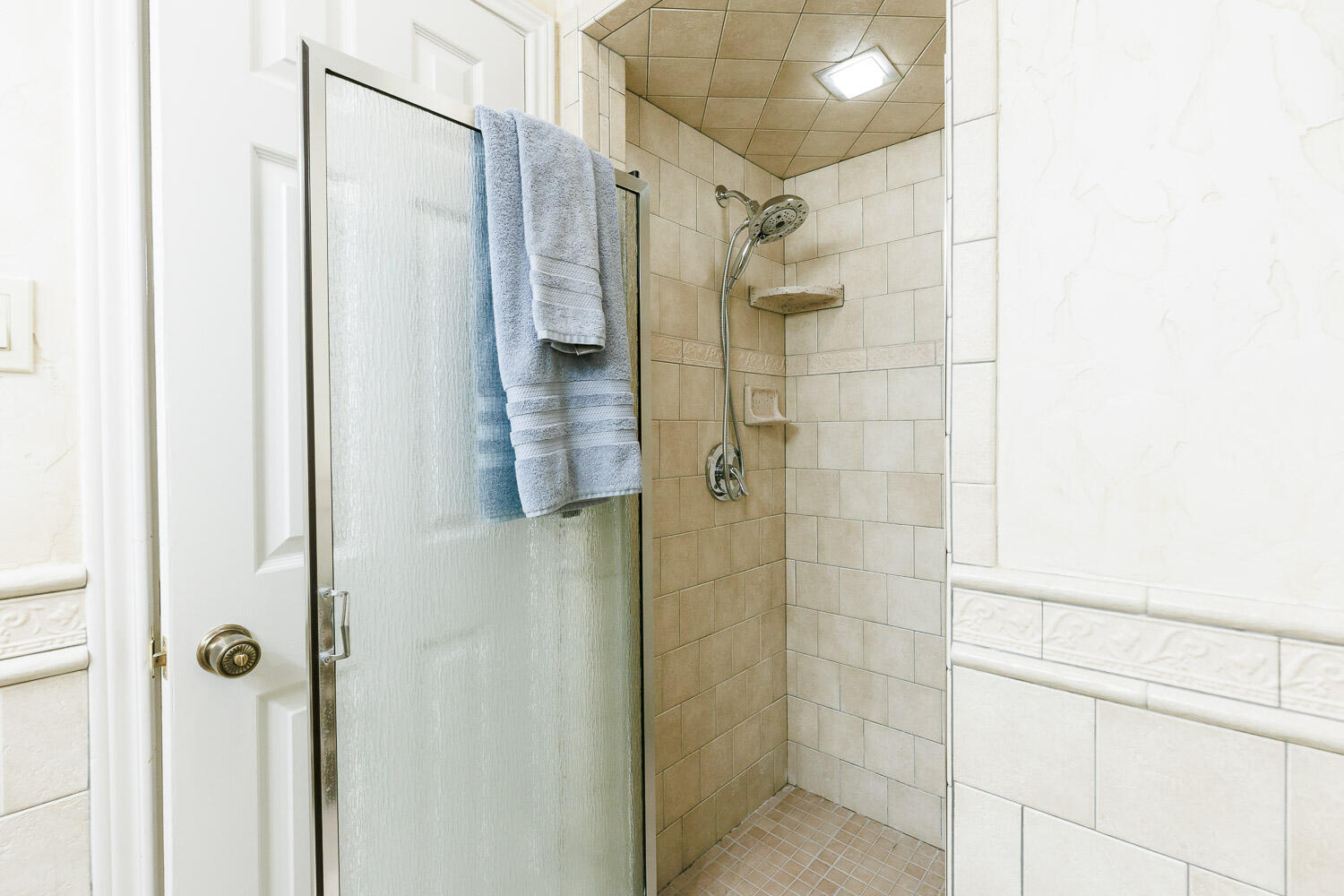 5717 72nd Street Lubbock, TX 79424 - Photo 36 of 54 a bathroom with a shower and a glass door