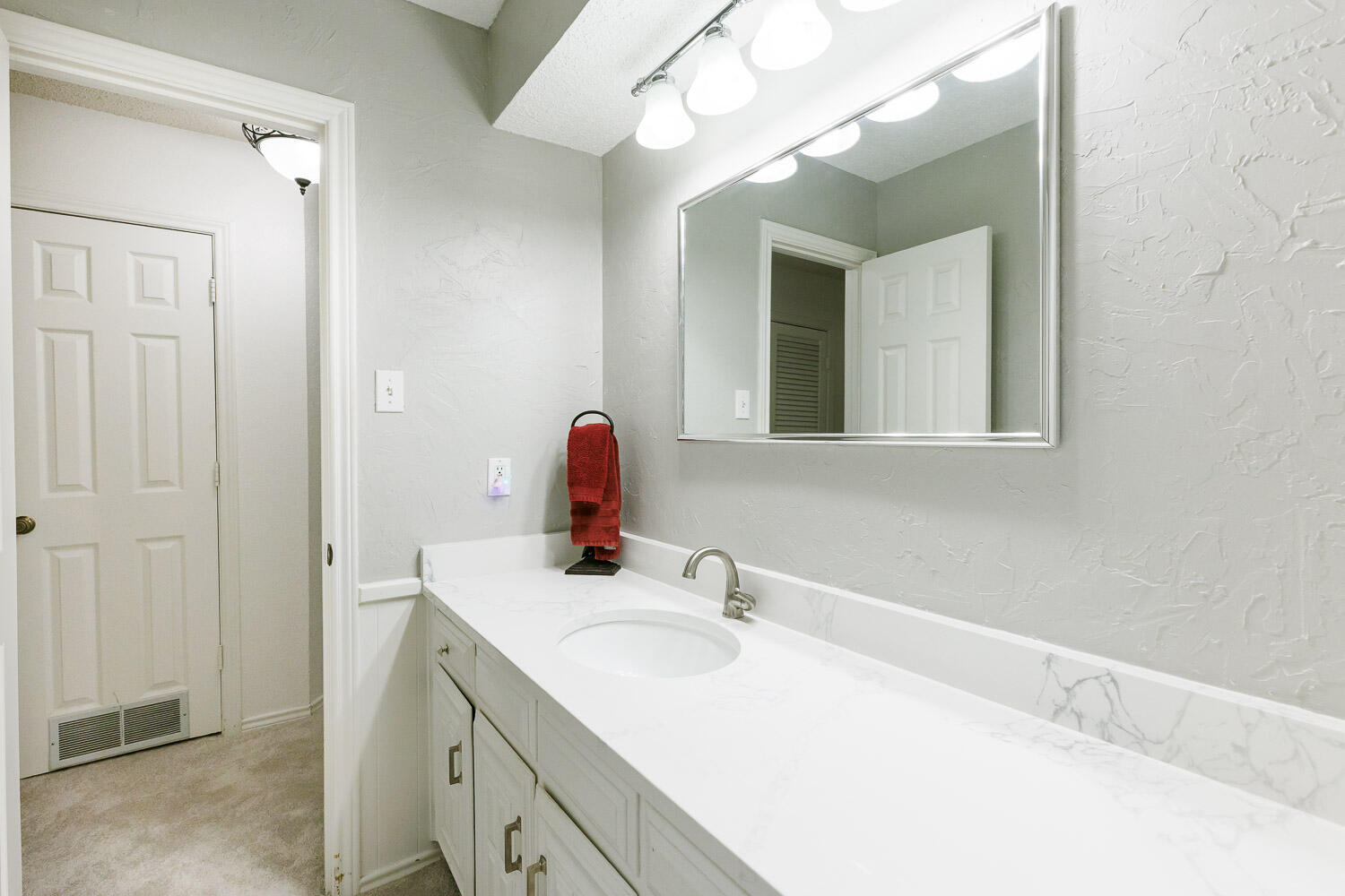 5717 72nd Street Lubbock, TX 79424 - Photo 40 of 54 a bathroom with a sink vanity and a mirror