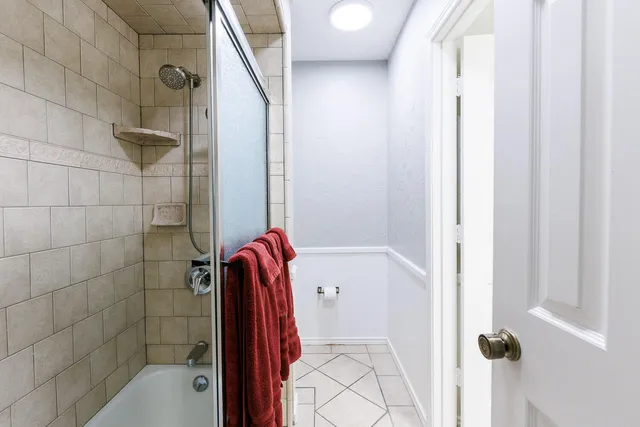 a room with pool table and windows