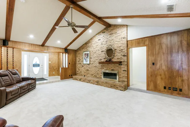a living room with a fireplace and a wooden floor