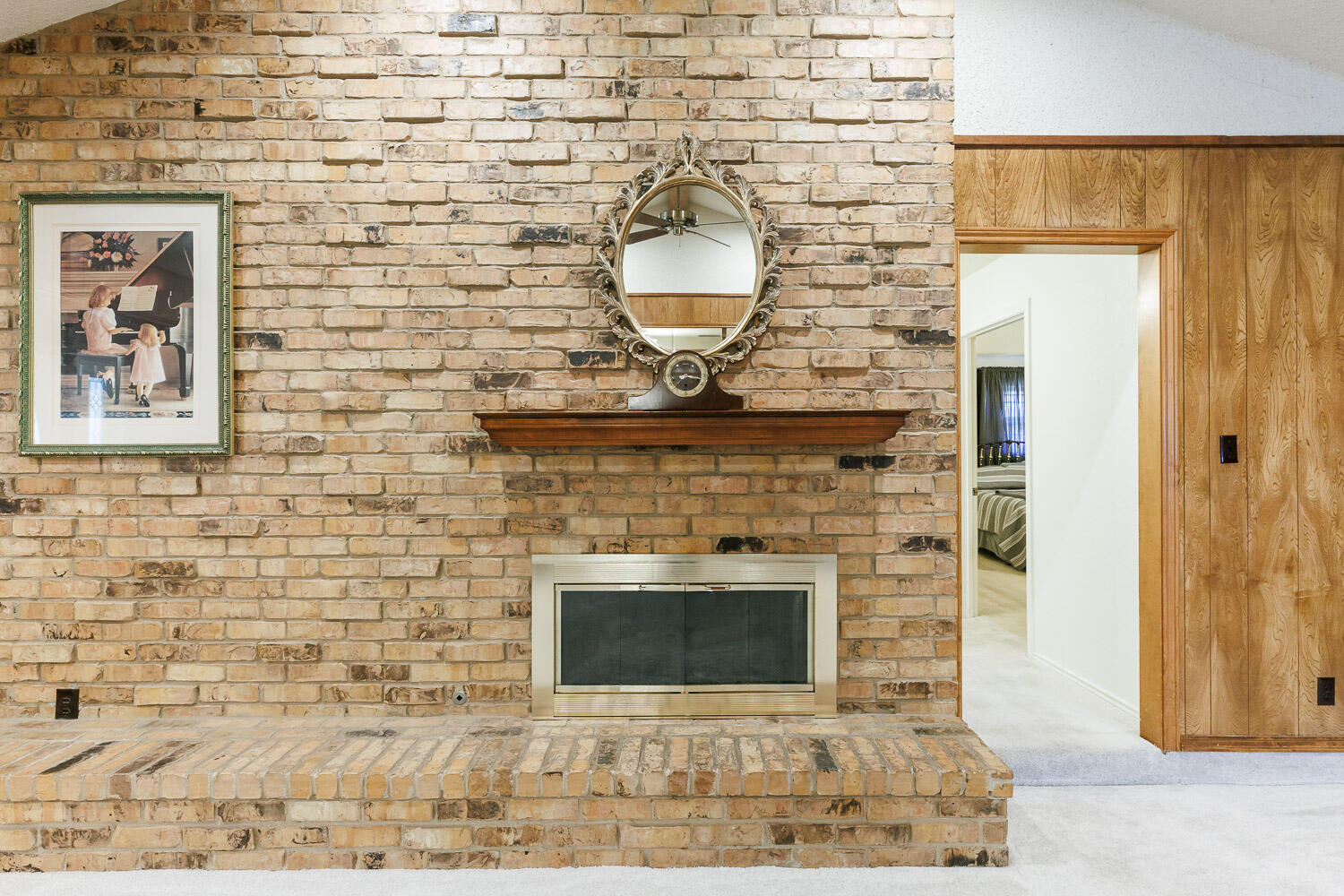 5717 72nd Street Lubbock, TX 79424 - Photo 8 of 54 a living room with a fireplace and a wooden floor