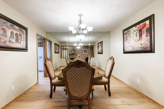 a view of a dining room with furniture and chandelier