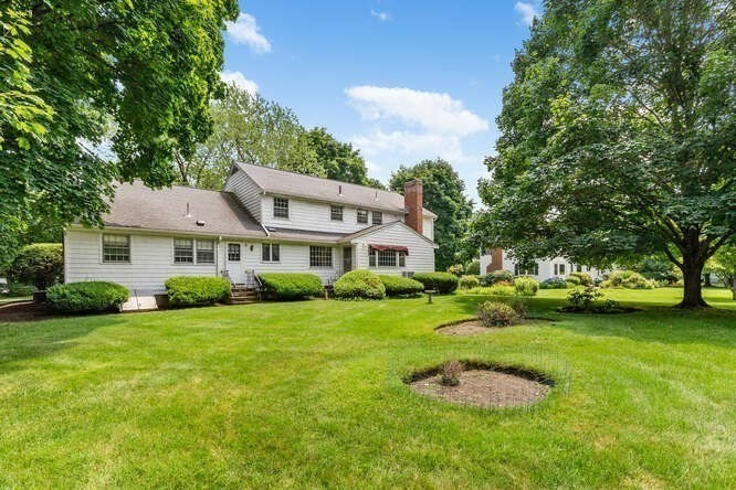 19 Saddle Club Road Lexington, MA 02420 - Photo 5 of 29 a front view of a house with garden