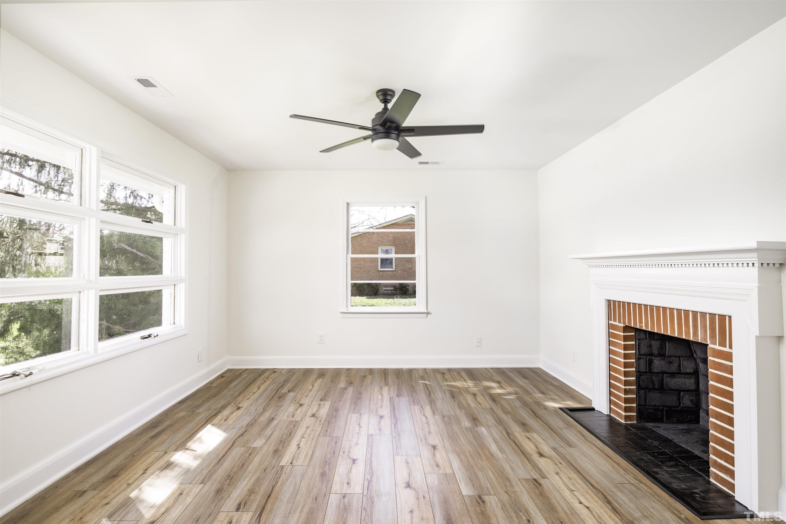 3555 Boston Road Roxboro, NC 27573 - Photo 4 of 21 wooden floor in an empty room with a fireplace