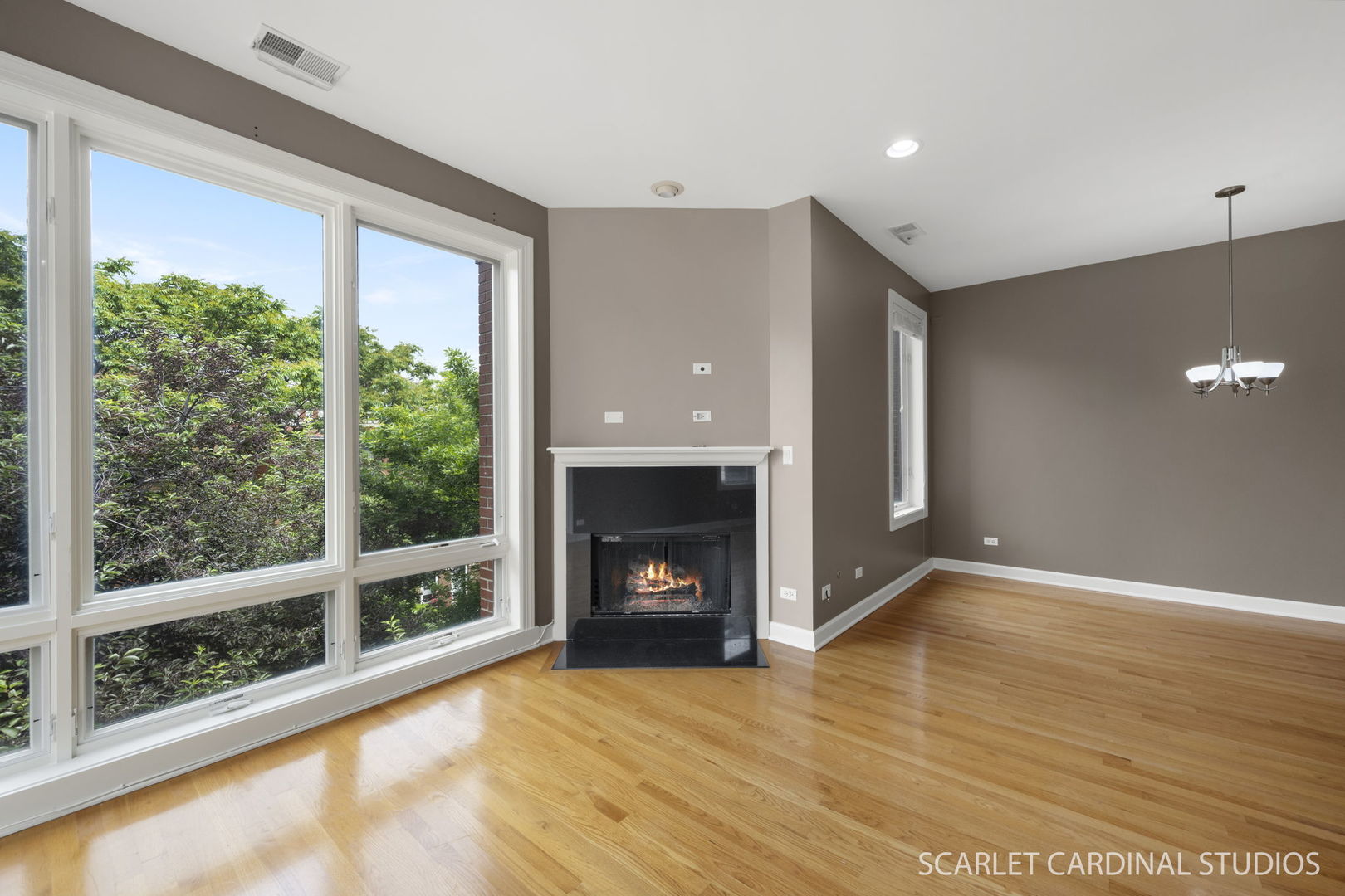 1419 West Fillmore Street, Unit 3W Chicago, IL 60607 - Photo 10 of 26 a view of an empty room with wooden floor fireplace and a window