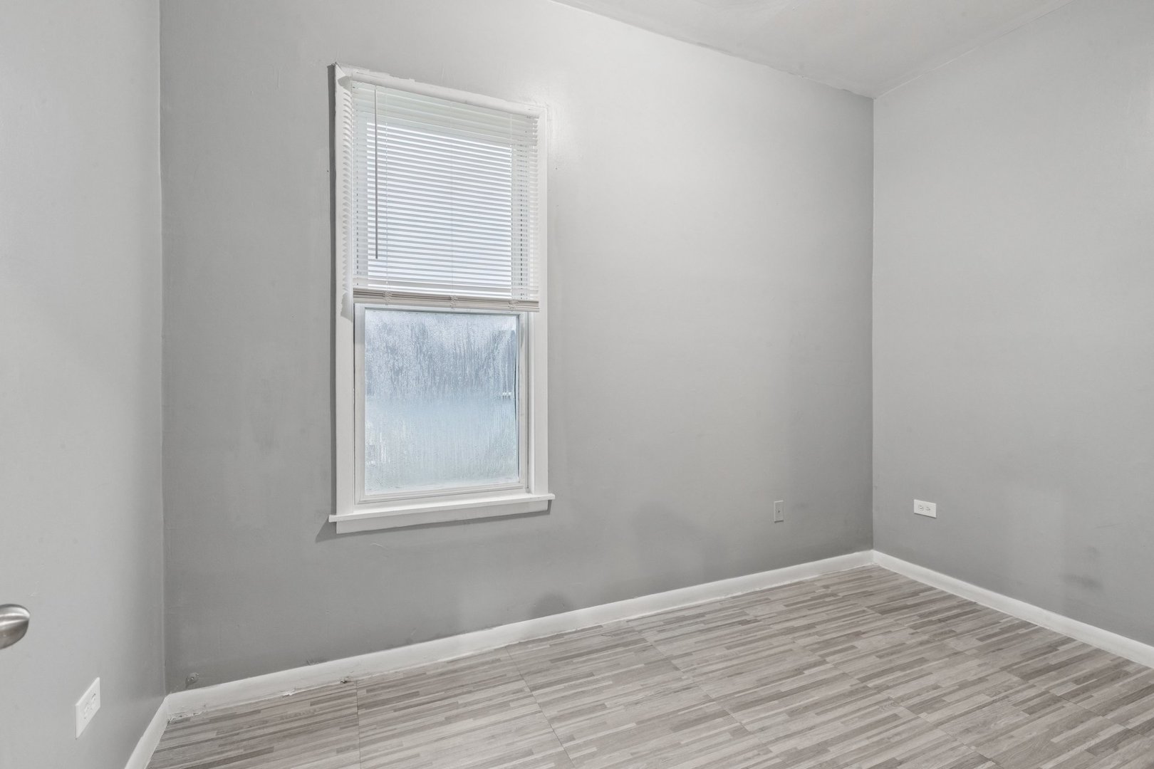 5756 South Princeton Avenue Chicago, IL 60621 - Photo 12 of 31 a view of an empty room with wooden floor and a window