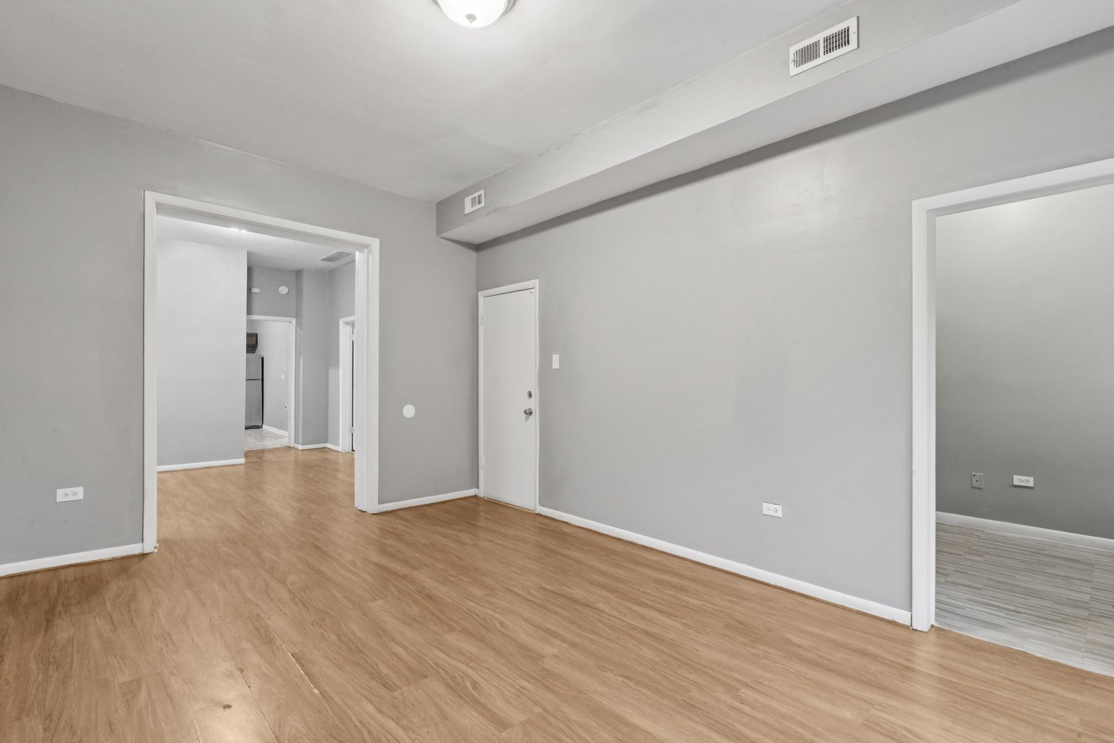 5756 South Princeton Avenue Chicago, IL 60621 - Photo 3 of 31 an empty room with wooden floor and windows