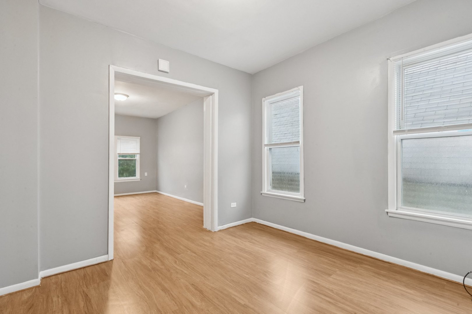 5756 South Princeton Avenue Chicago, IL 60621 - Photo 5 of 31 an empty room with wooden floor and windows