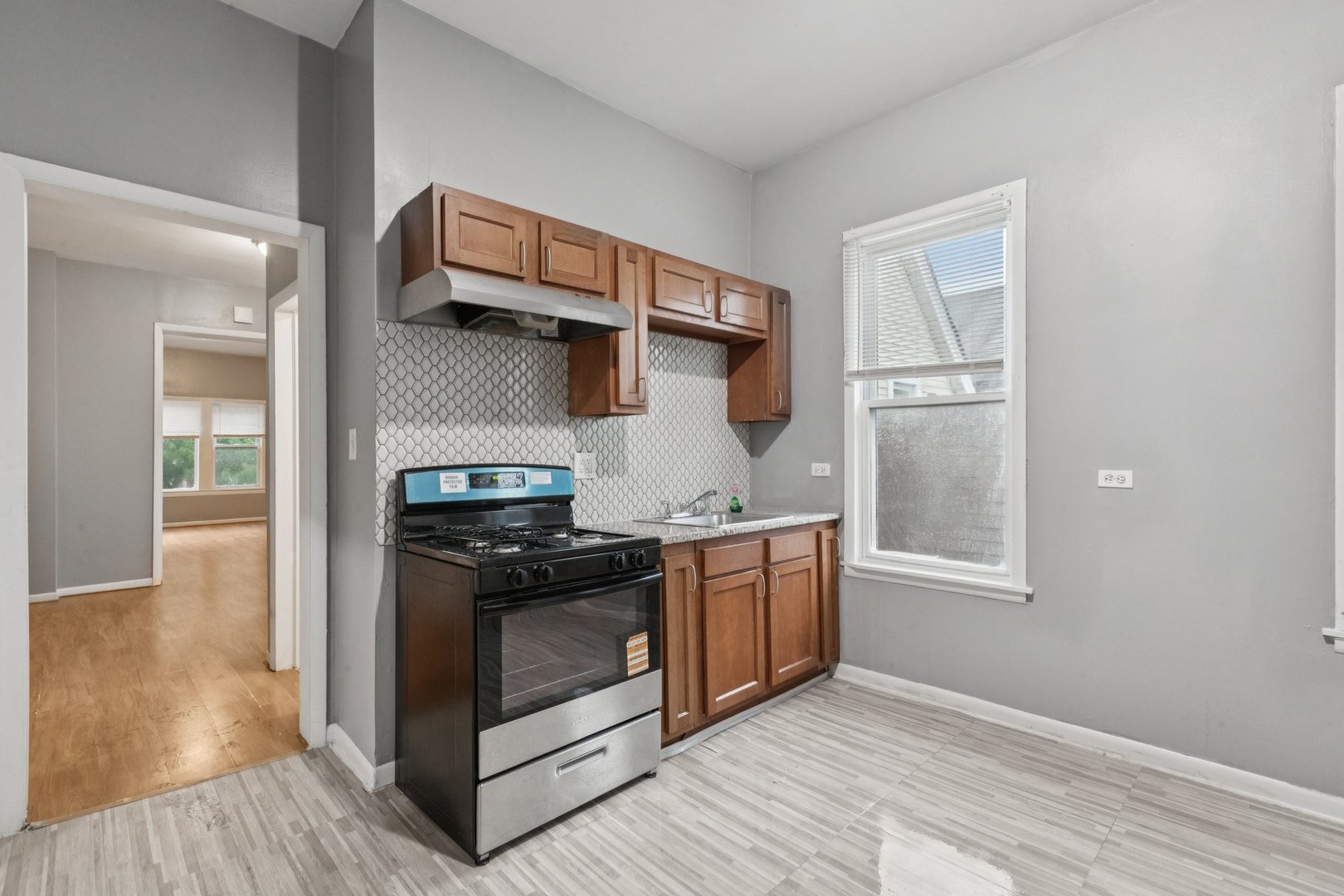 5756 South Princeton Avenue Chicago, IL 60621 - Photo 8 of 31 a kitchen with stainless steel appliances granite countertop a stove and a refrigerator