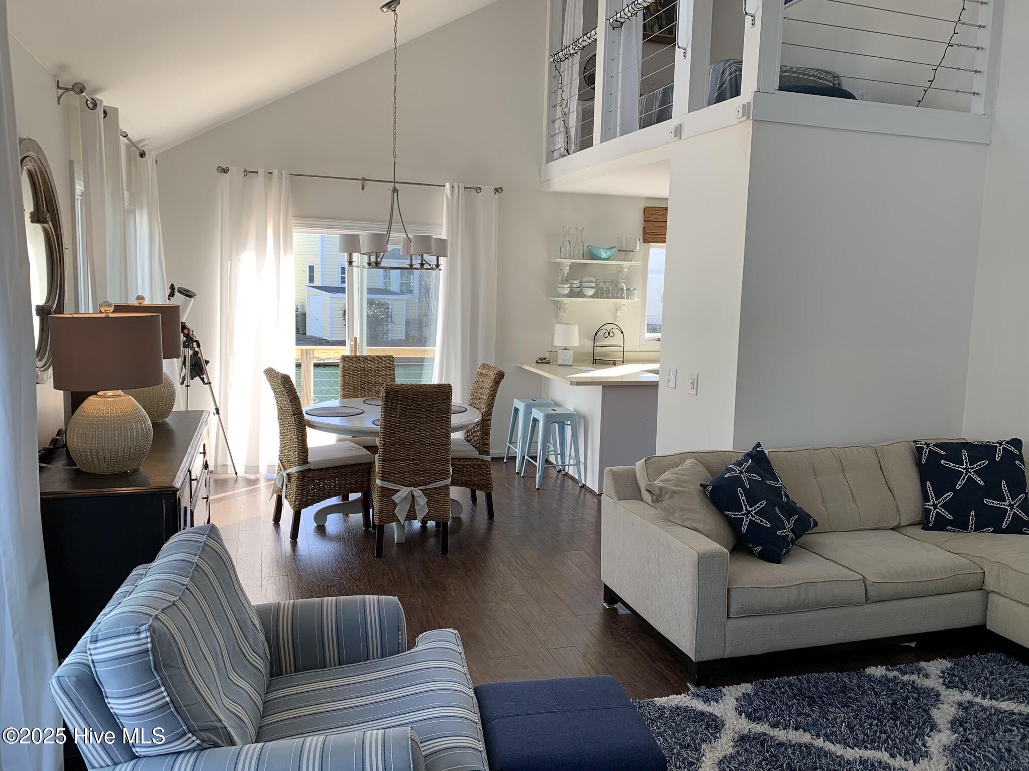 213 Sandfiddler East Emerald Isle, NC 28594 - Photo 12 of 44 Living room open to dining room with fun reading loft.