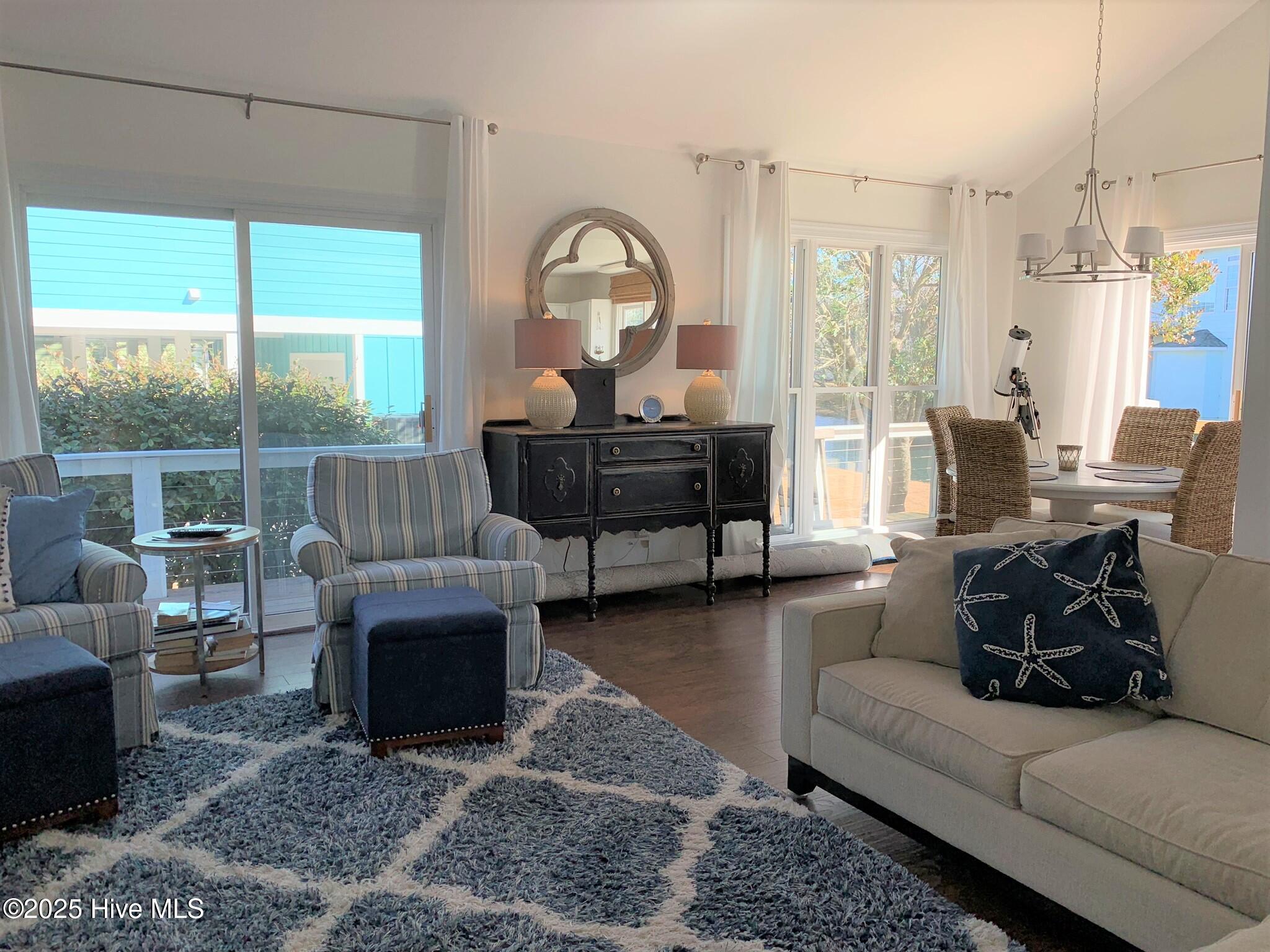 213 Sandfiddler East Emerald Isle, NC 28594 - Photo 13 of 44 Living room with slider to wrap around deck