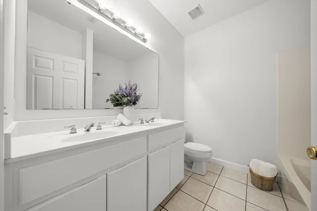 a bathroom with a sink a toilet and mirror
