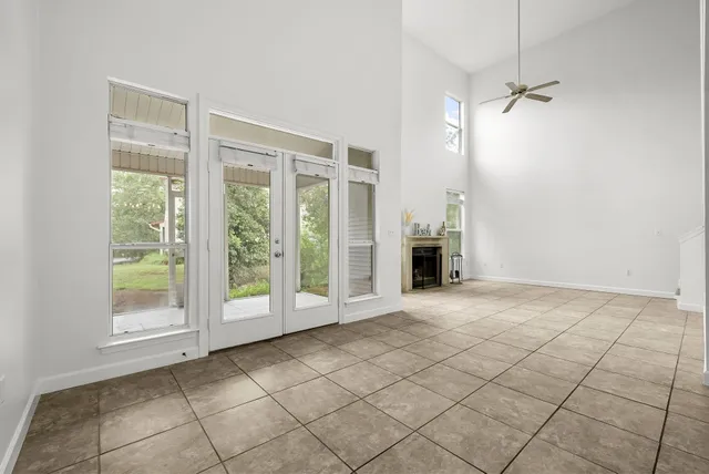 a view of an empty room with a fireplace and a window