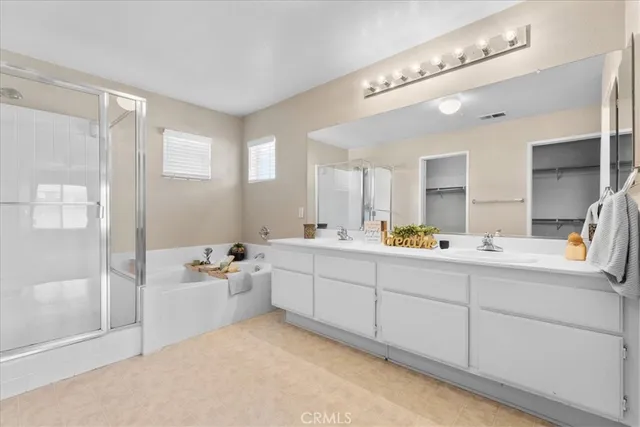 a bathroom with a tub a sink and mirrors