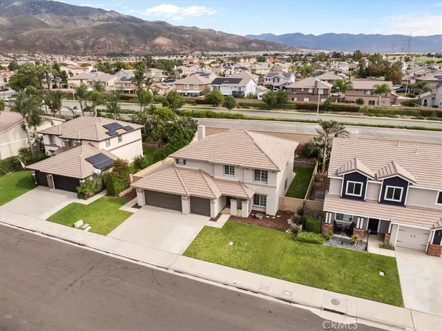an aerial view of a house with a garden and lake view