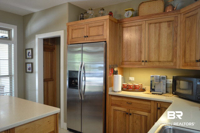 8919 Red Fish Pt Road Lillian, AL 36549 - Photo 16 of 46 Stainless Kitchen Aid appliances. Walk around pantry.