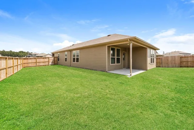 a front view of a house with yard and lake view
