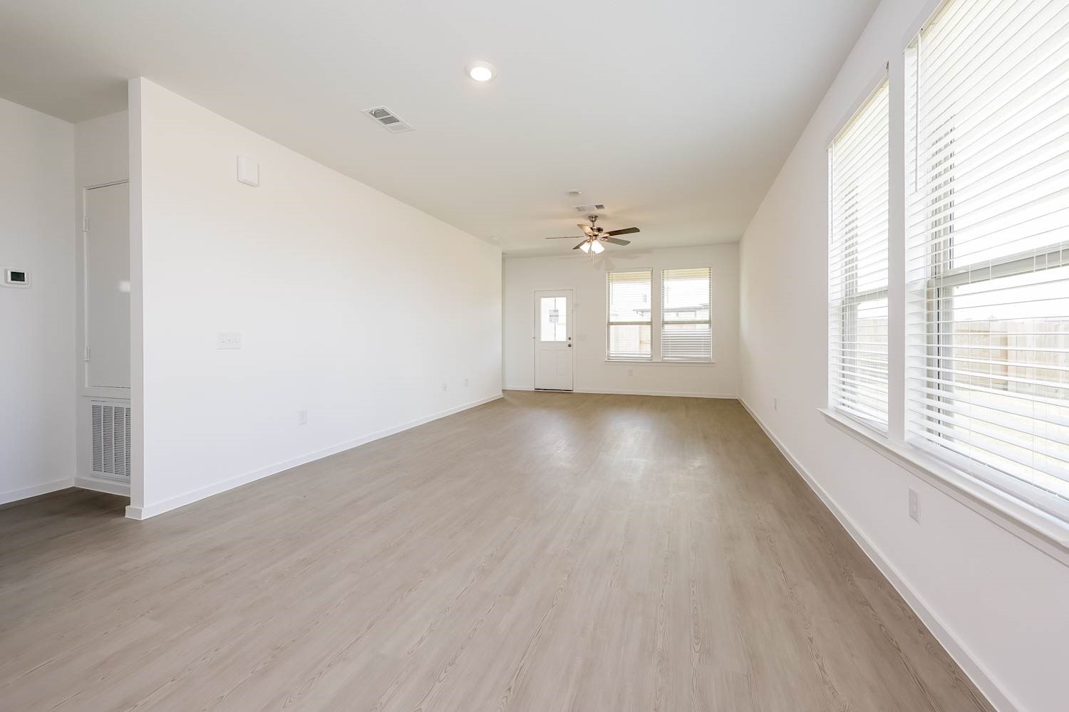 15243 Canyon Rapids Road Conroe, TX 77302 - Photo 4 of 15 an empty room with wooden floor and windows