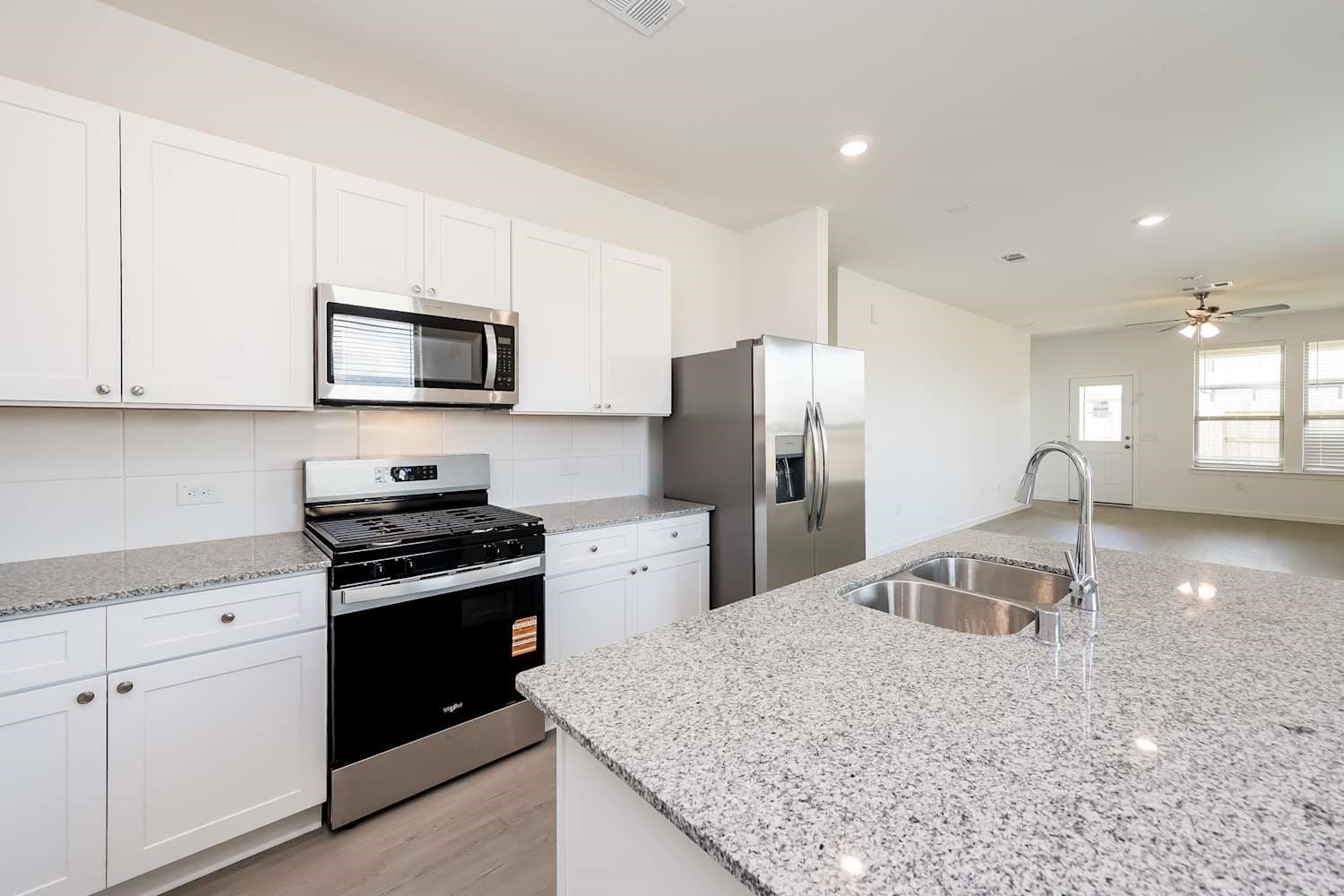 15243 Canyon Rapids Road Conroe, TX 77302 - Photo 7 of 15 a kitchen with refrigerator stove and microwave