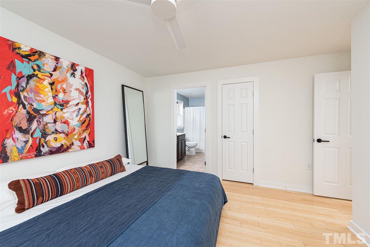 905 Dorothy Sanders Way Raleigh, NC 27601 - Photo 14 of 28 a bedroom with a bed and a couch