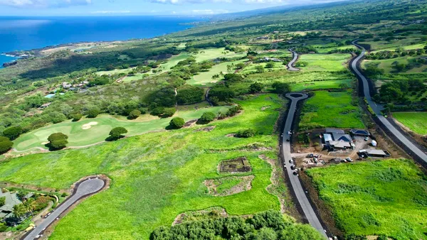 a view of a field with an ocean