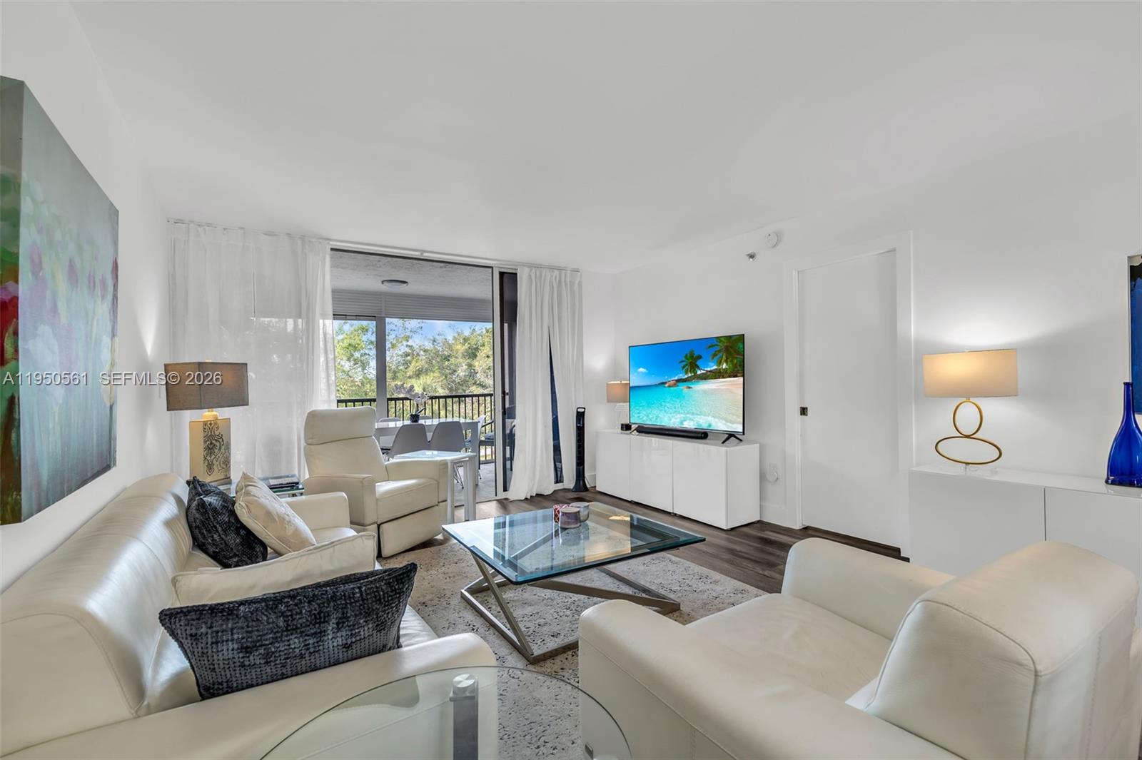 3910 Inverrary Boulevard, Unit 503B Lauderhill, FL 33319 - Photo 11 of 37 a living room with furniture and a large window