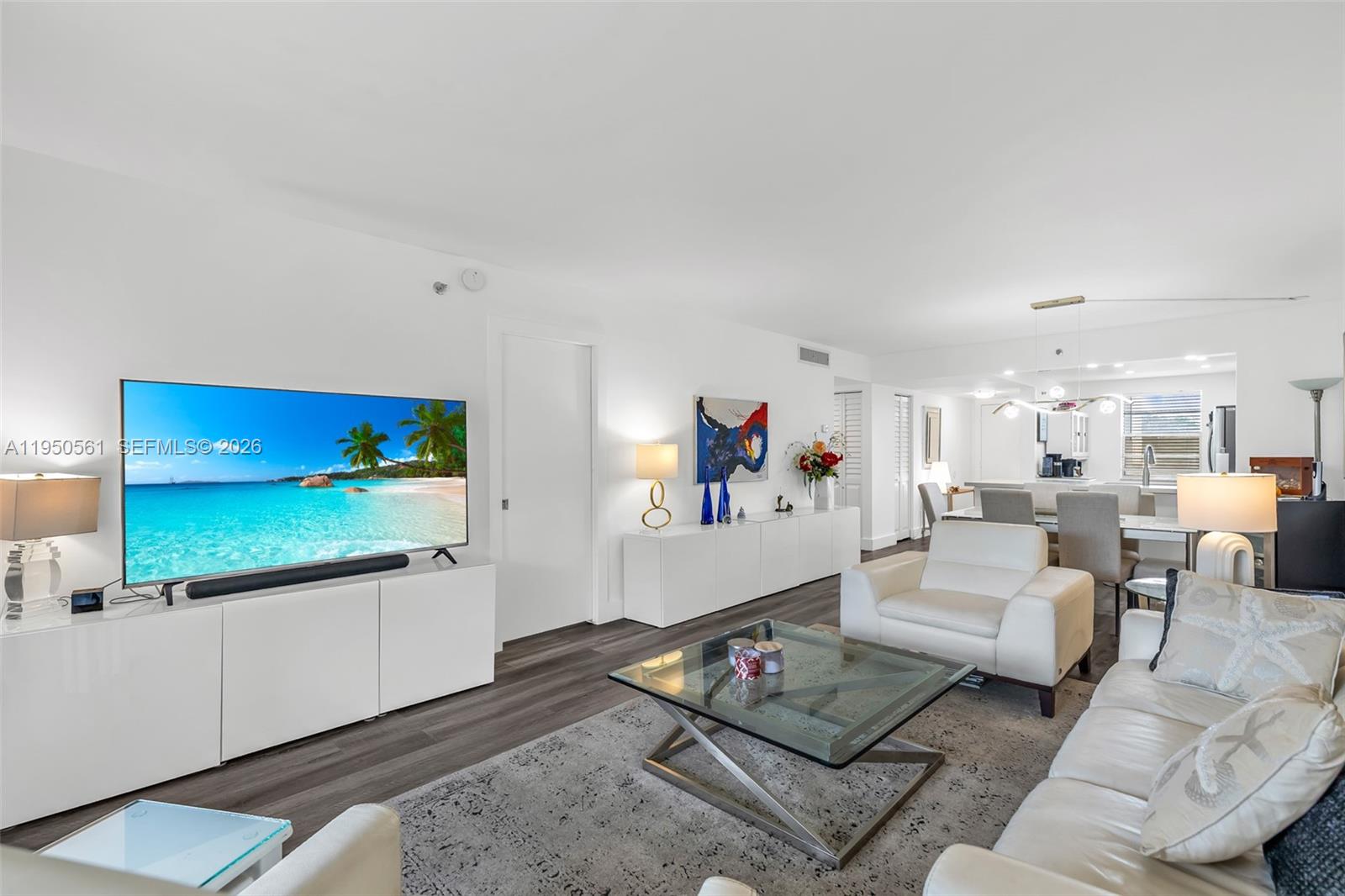 3910 Inverrary Boulevard, Unit 503B Lauderhill, FL 33319 - Photo 13 of 37 a living room with furniture and a flat screen tv
