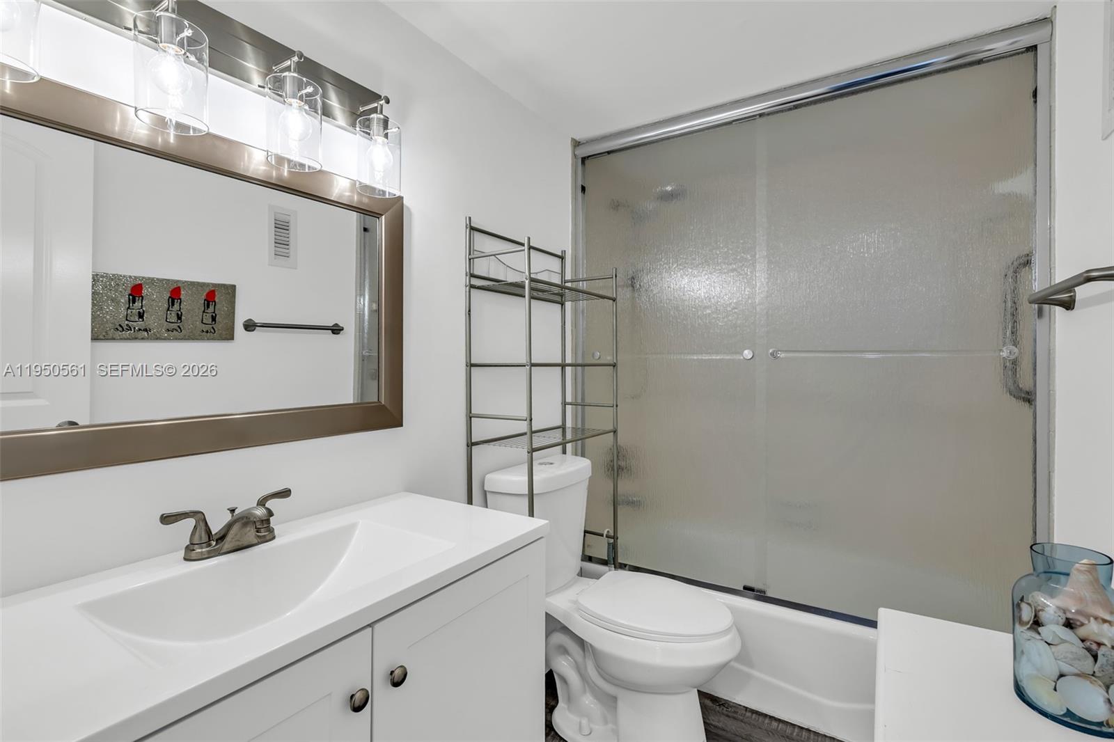 3910 Inverrary Boulevard, Unit 503B Lauderhill, FL 33319 - Photo 15 of 37 a bathroom with a sink toilet and shower