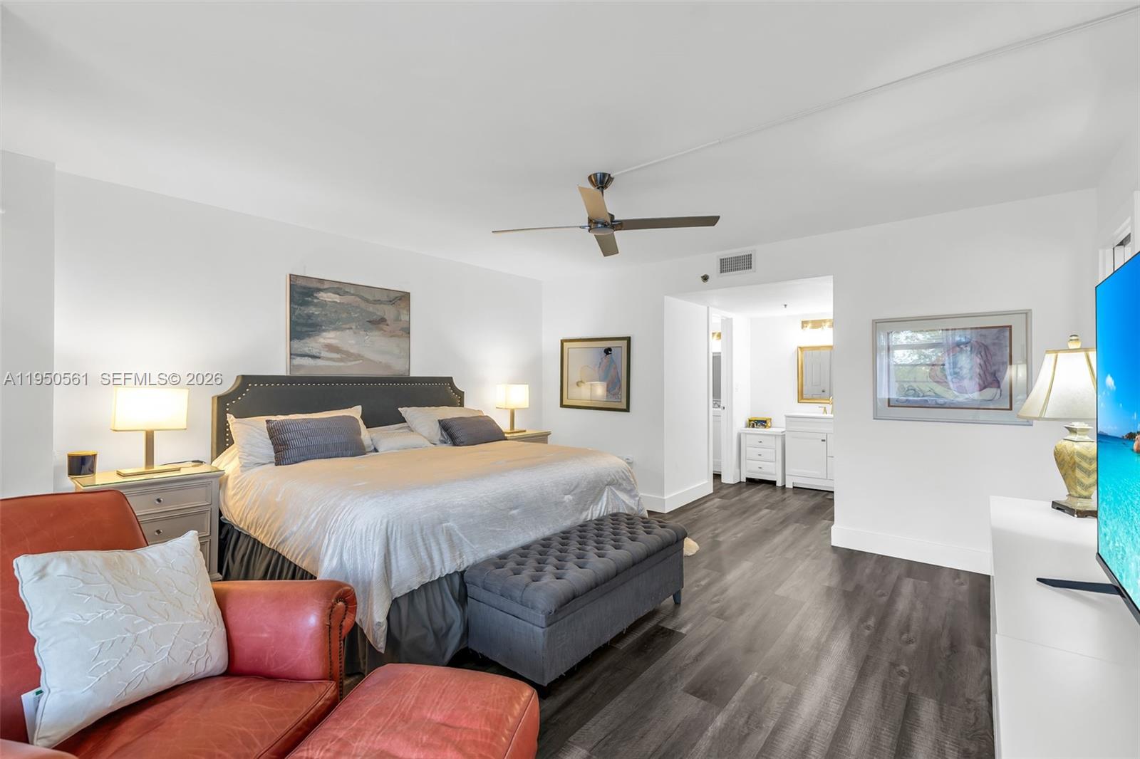 3910 Inverrary Boulevard, Unit 503B Lauderhill, FL 33319 - Photo 18 of 37 a bedroom with a bed couch and a view of kitchen