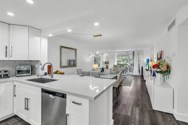 a view of a hallway with wooden floor and workspace
