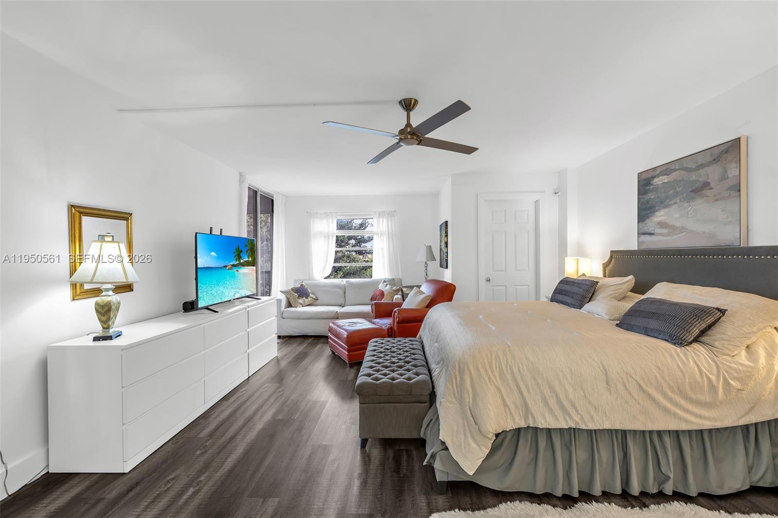 3910 Inverrary Boulevard, Unit 503B Lauderhill, FL 33319 - Photo 22 of 37 a bedroom with a bed and wooden floor