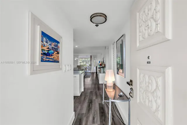 a kitchen with white cabinets stainless steel appliances and sink