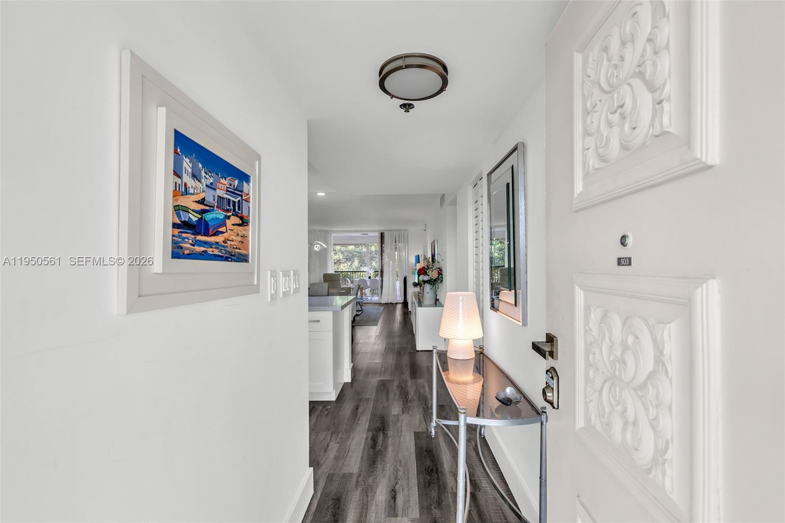 3910 Inverrary Boulevard, Unit 503B Lauderhill, FL 33319 - Photo 3 of 37 a view of a hallway with wooden floor and workspace