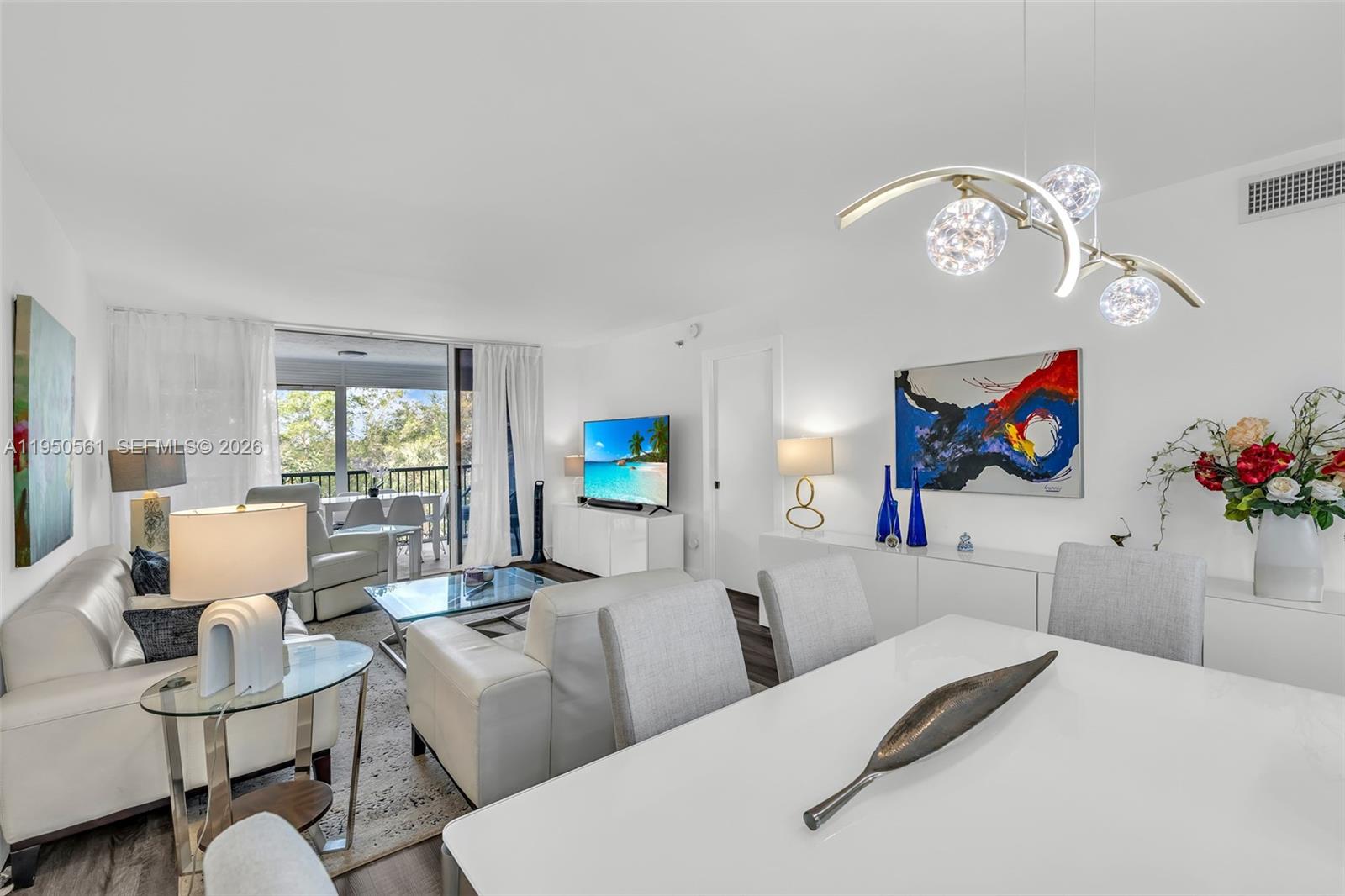 3910 Inverrary Boulevard, Unit 503B Lauderhill, FL 33319 - Photo 7 of 37 a living room with furniture chandelier and a window