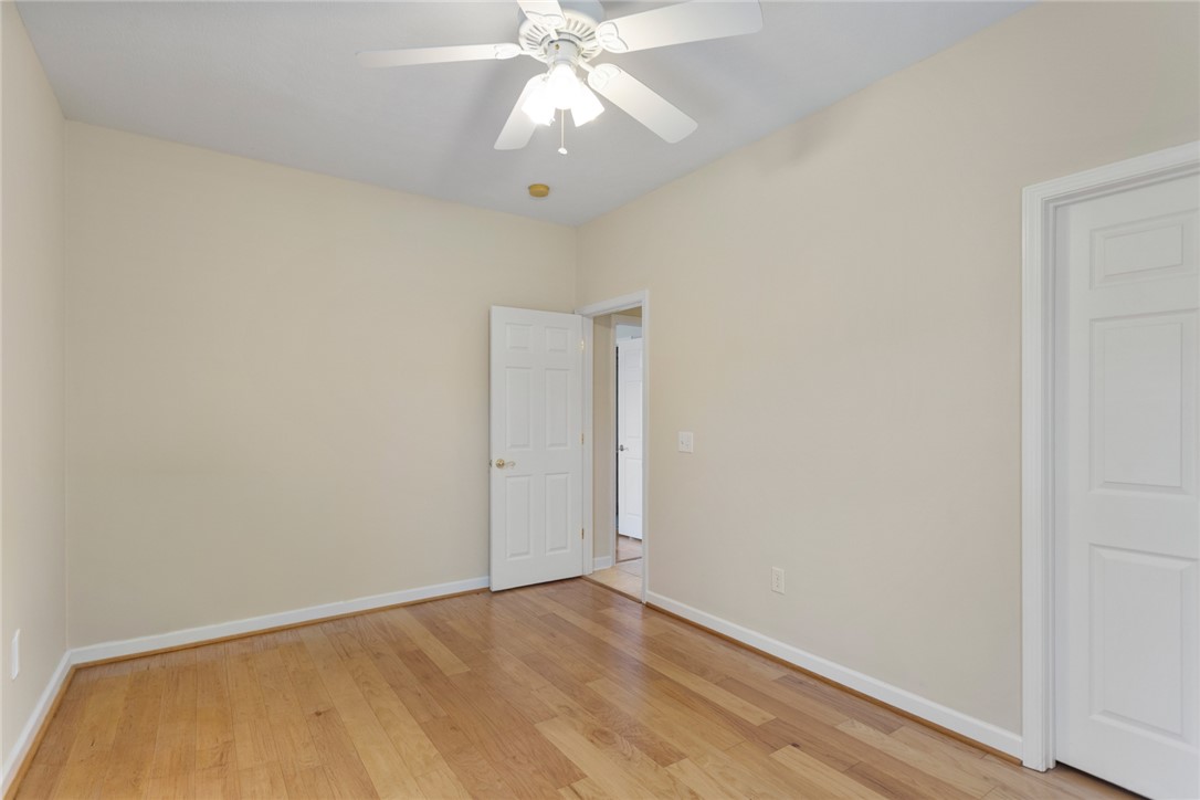 155 Life Style Lane Anderson, SC 29621 - Photo 26 of 49 This airy bedroom features bright walls and polished hardwood floors, offering a versatile space.