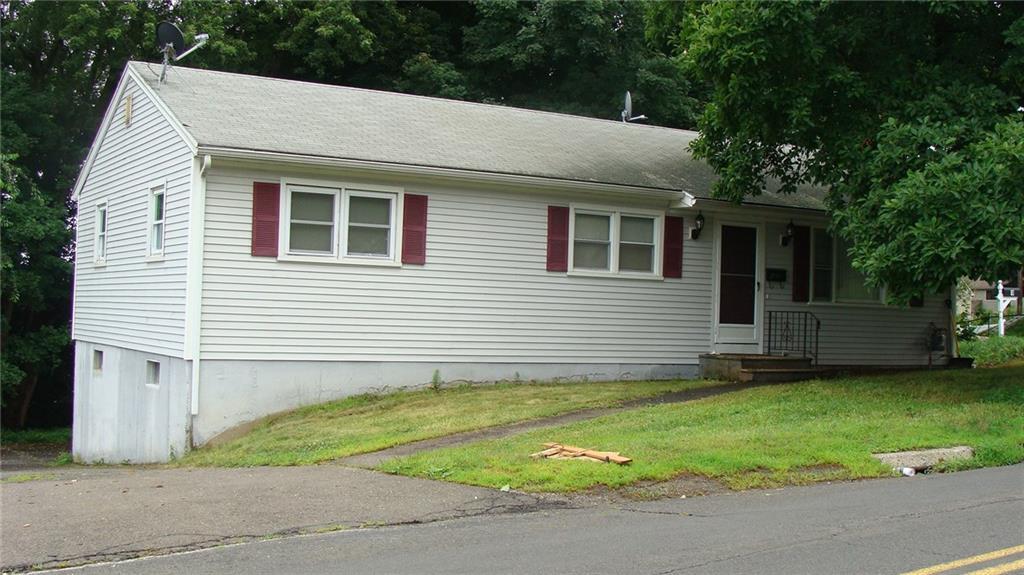 a view of a house with a yard and a garage