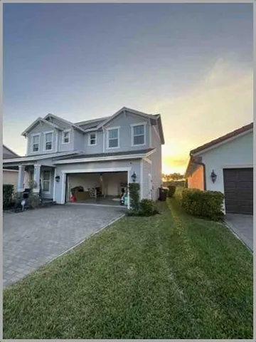 a front view of a house with a yard and garage