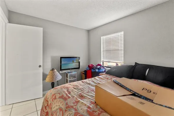 a bedroom with a bed and a flat tv screen