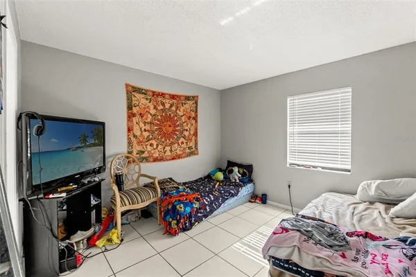 a bedroom with bed and a flat screen tv