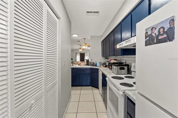 a kitchen with stainless steel appliances a stove a sink and a refrigerator