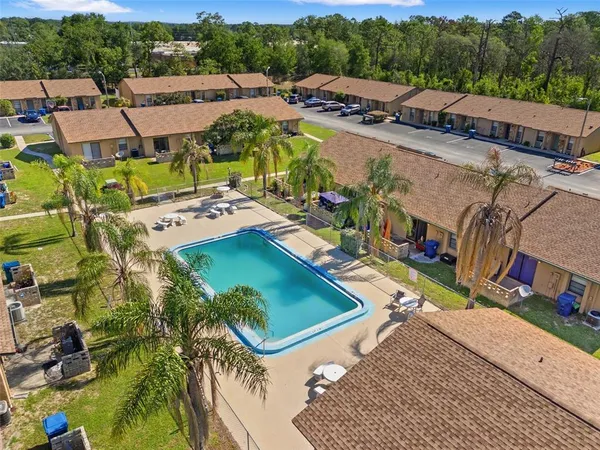 an aerial view of a house with a garden and lake view