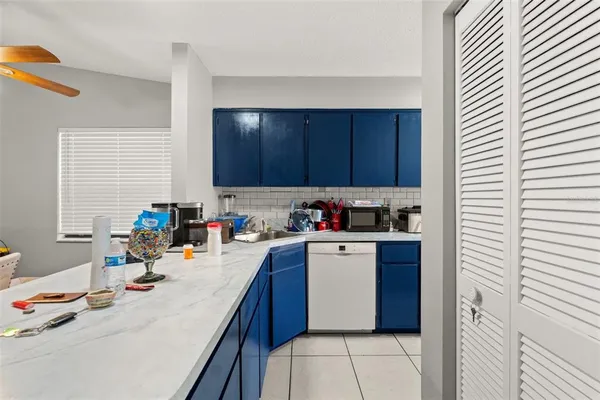 a kitchen with a sink a stove and cabinets