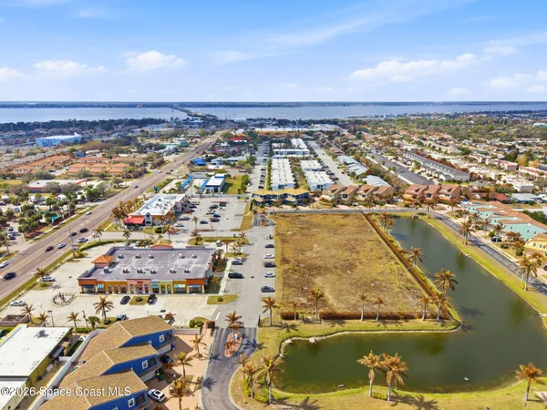 an aerial view of residential building and ocean