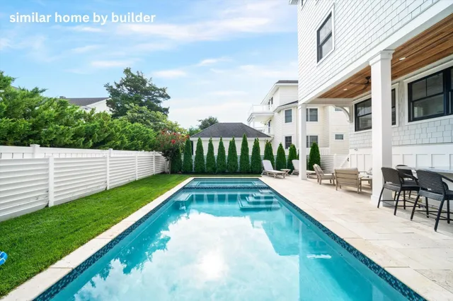 a kitchen with granite countertop a stove a sink and a refrigerator