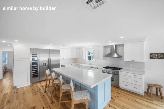 a large kitchen with stainless steel appliances a lot of counter space and a sink