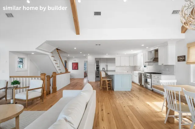 a living room with fireplace furniture and a wooden floor
