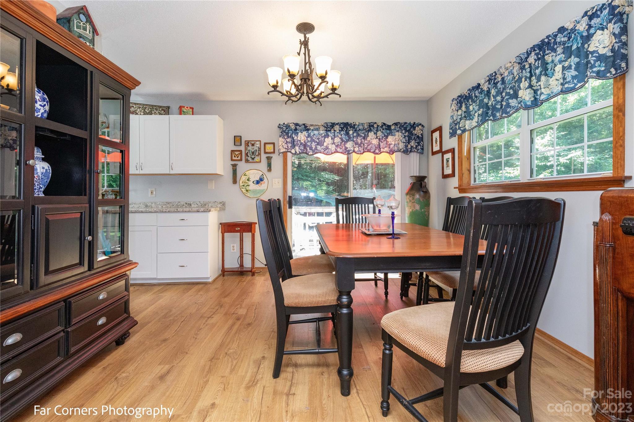 1454 Sorrells Cove Road Clyde, NC 28721 - Photo 14 of 26 a view of a dining room with furniture a chandelier and wooden floor