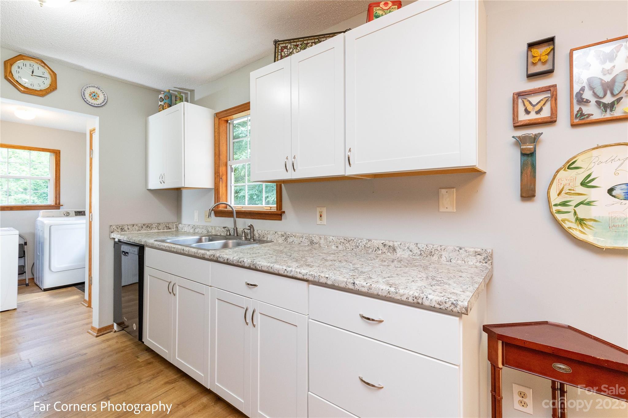 1454 Sorrells Cove Road Clyde, NC 28721 - Photo 17 of 26 a kitchen with granite countertop white cabinets and a stove