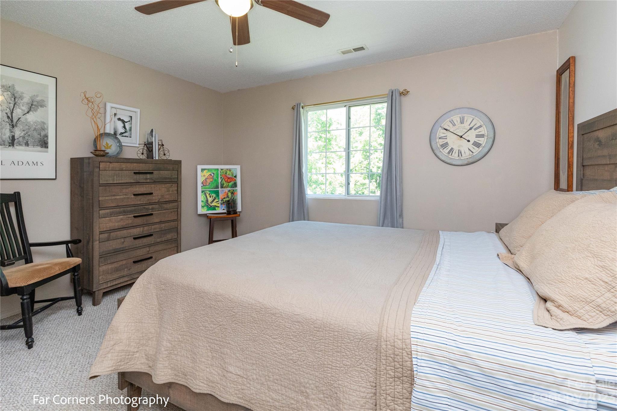 1454 Sorrells Cove Road Clyde, NC 28721 - Photo 23 of 26 a bedroom with a bed and a chandelier