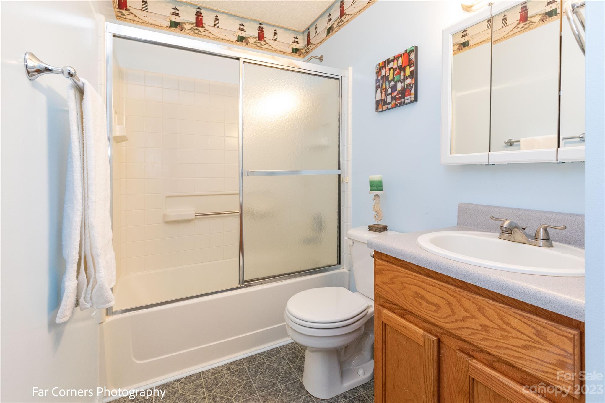 1454 Sorrells Cove Road Clyde, NC 28721 - Photo 25 of 26 a bathroom with a sink a toilet and shower